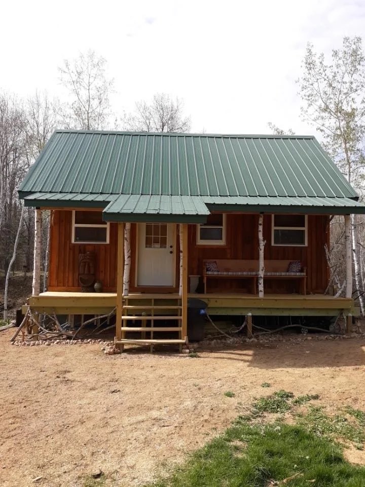 A finished cabin standing on bare graded ground