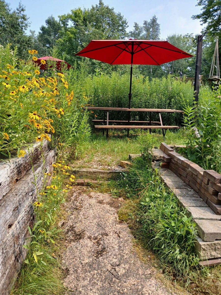 A picnic table under the red umbrella